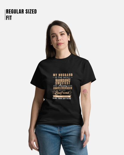 Woman wearing a black t-shirt with text, standing against a white background