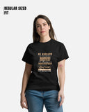 Woman wearing a black t-shirt with text, standing against a white background